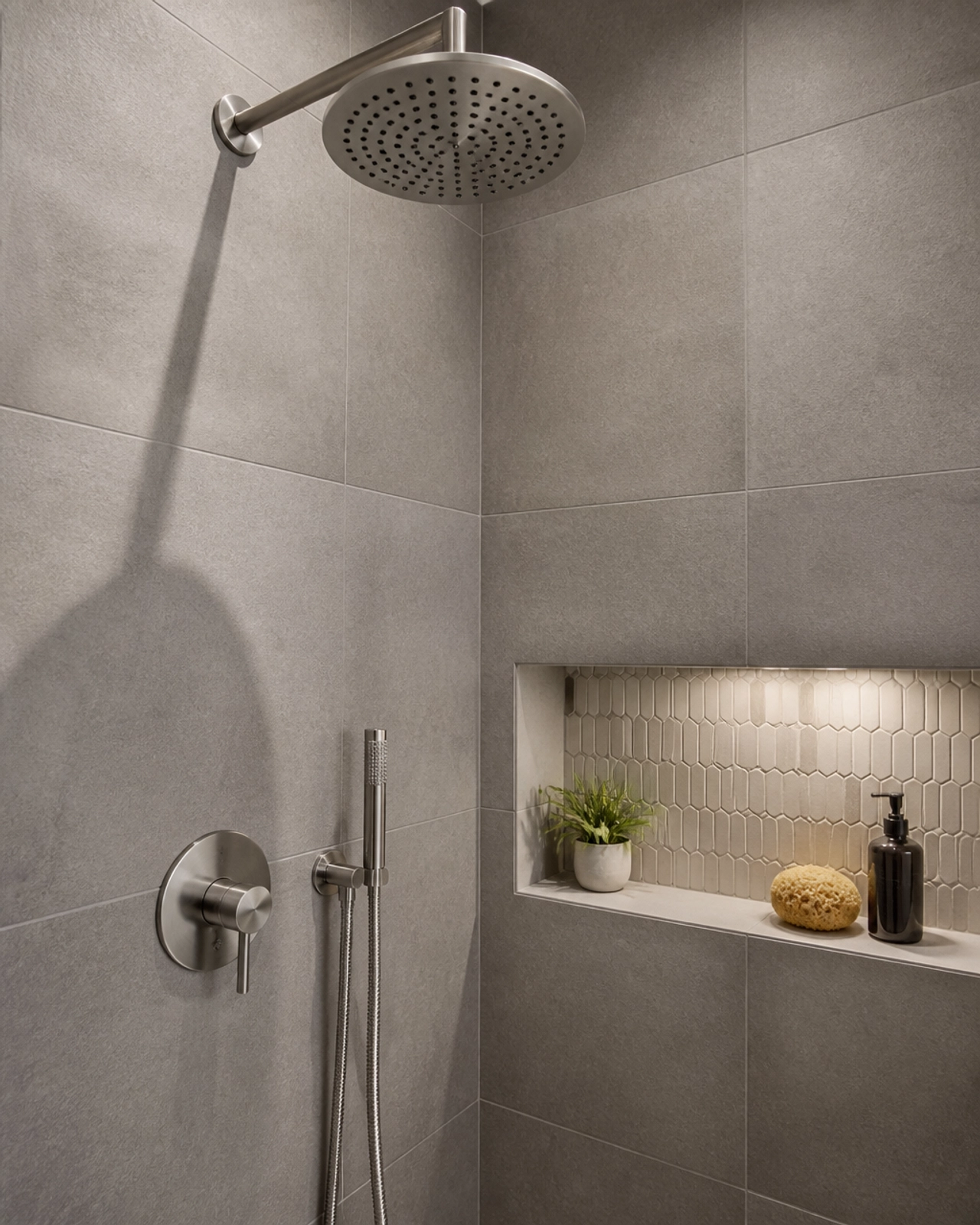 Close-up of a high-end white quartz countertop with a sophisticated glass tile backsplash in a chevron pattern.